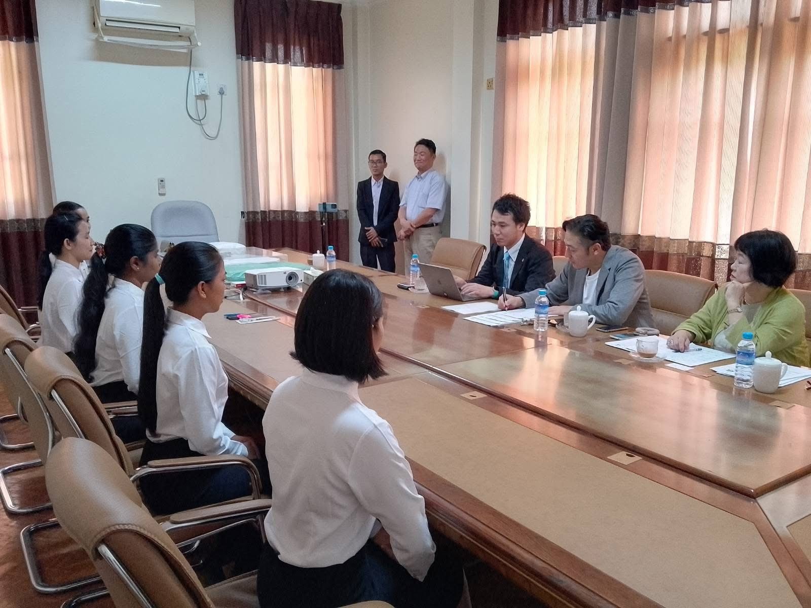 People gathered around a conference table in a meeting room